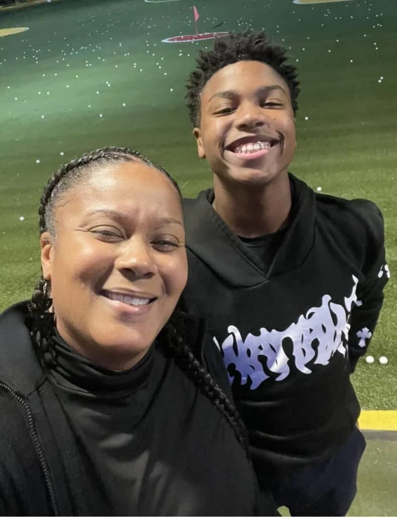 Single mother and son Noah smiling together at community outing